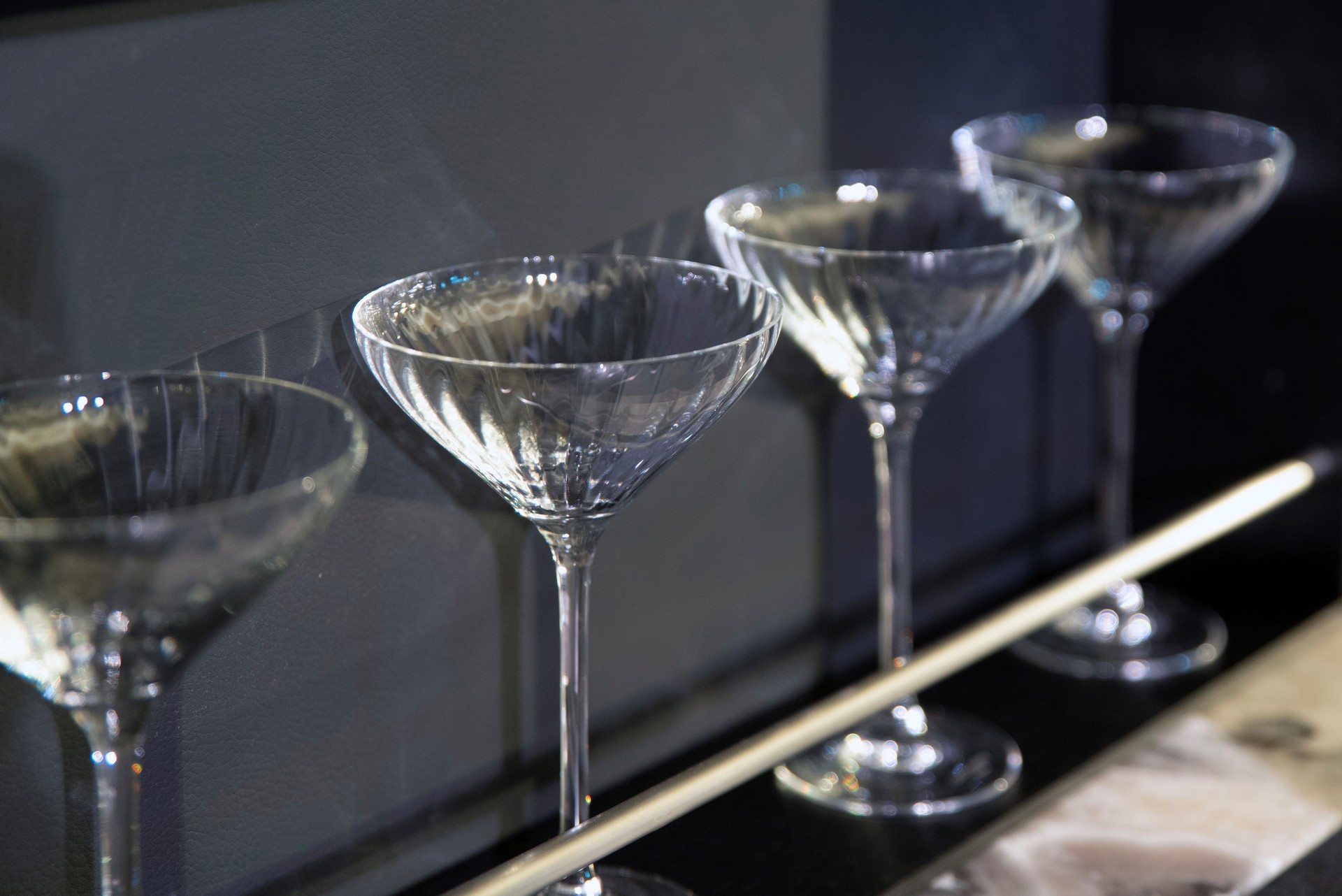 Faceted crystal coupe glasses in bar display